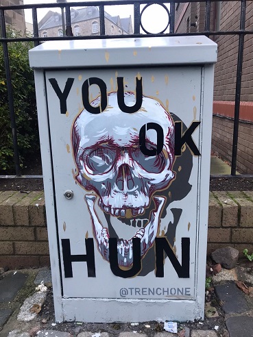 A mural painted on by artist Trench One with a skull present and 'You OK Hun?' painted on it. 