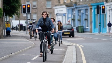 Lady riding bike in segregated bike lane