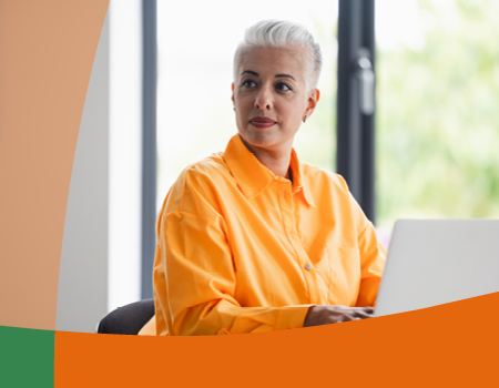 Woman sitting working on a laptop