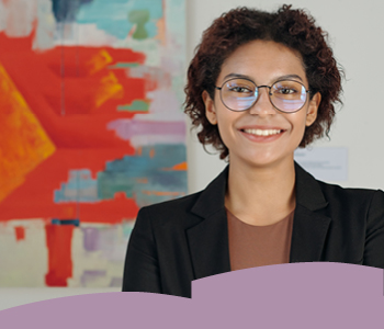 Woman with glasses standing in front of a painting.