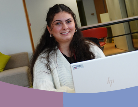 Woman sitting in front if a laptop