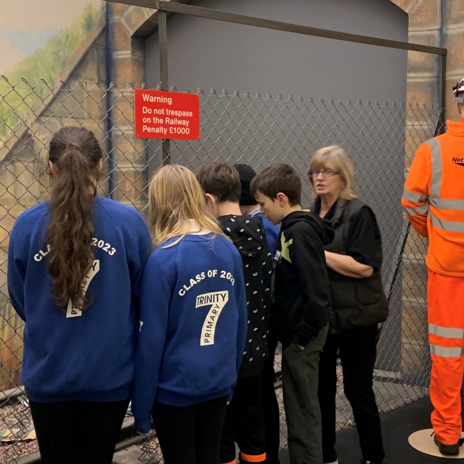 Volunteer speaking to group in the Rail scenario