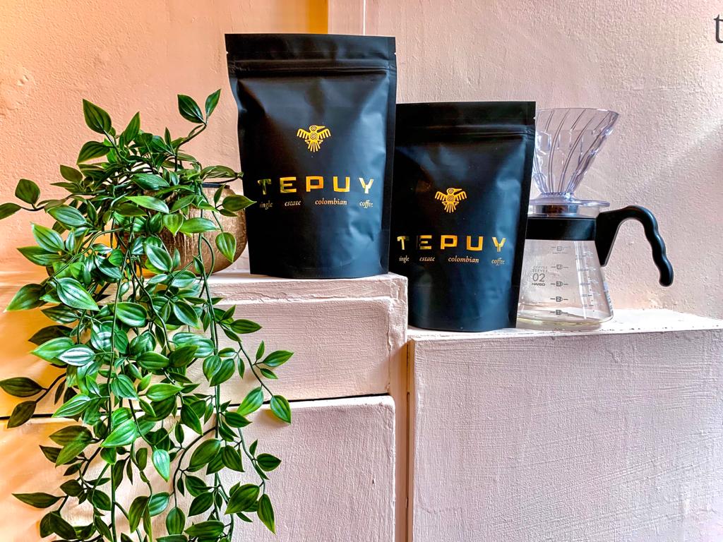 Bags of Coffee Tepuy with a house plant.