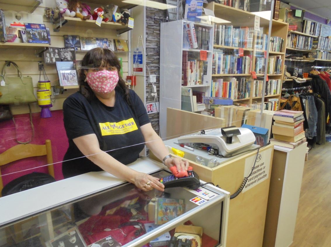 Image of All Together Edinburgh worker inside their Charity Shop on Leith Walk